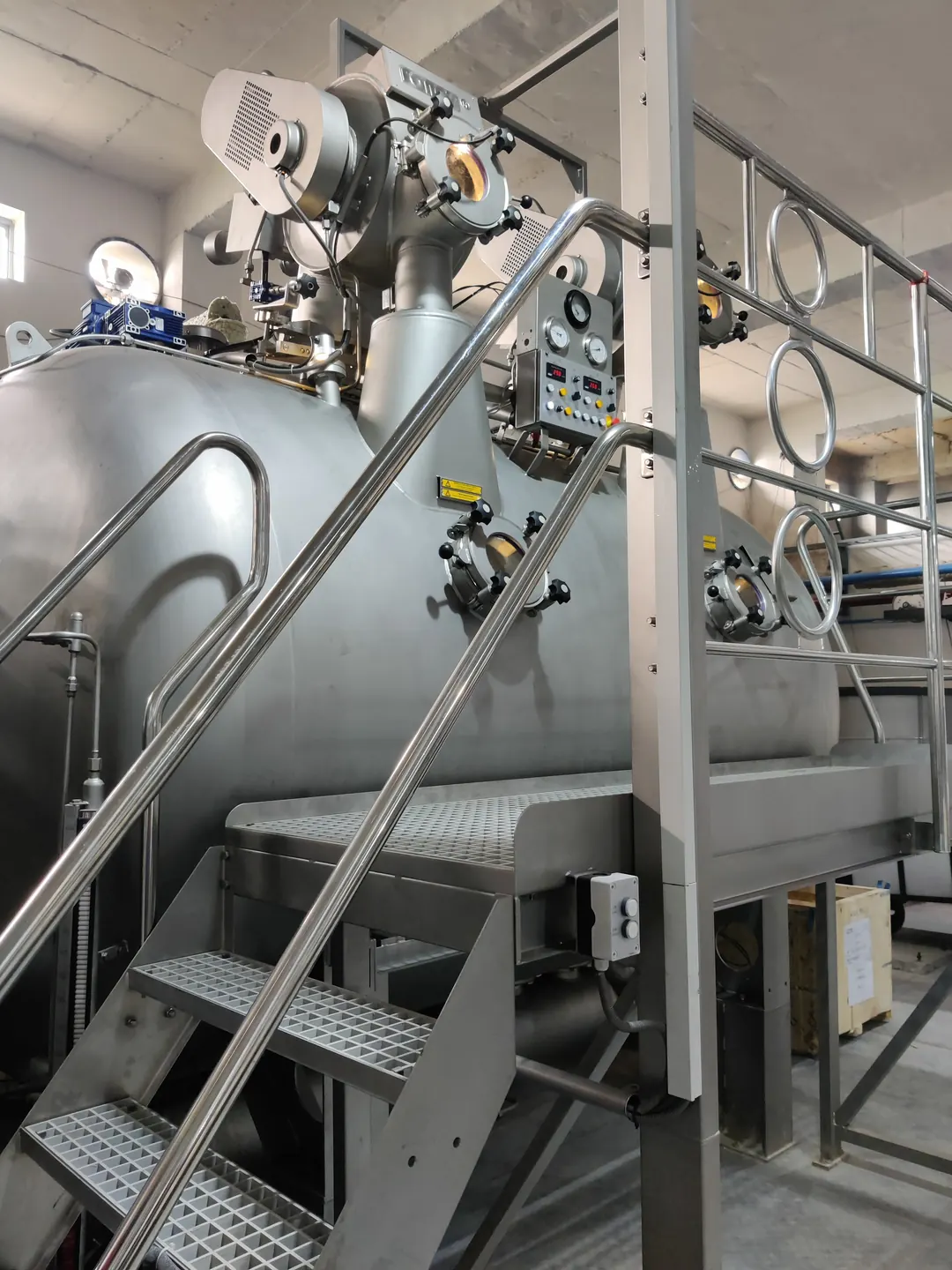 Stainless-steel soft-flow fabric dyeing machine inside a dyehouse